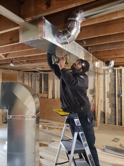 A person repairing a duct