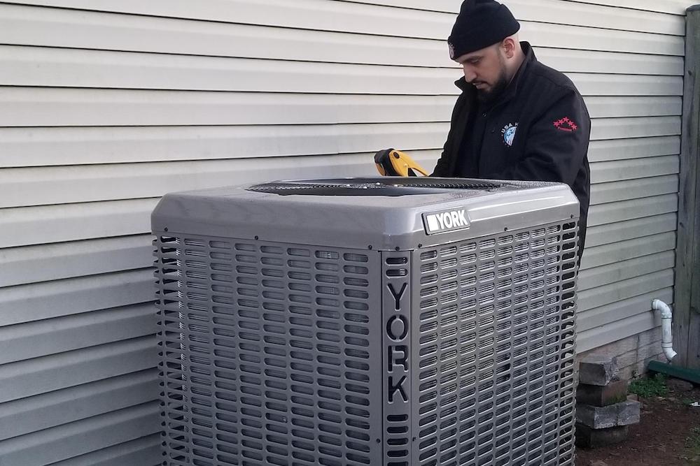 A man is working on an air conditioner.