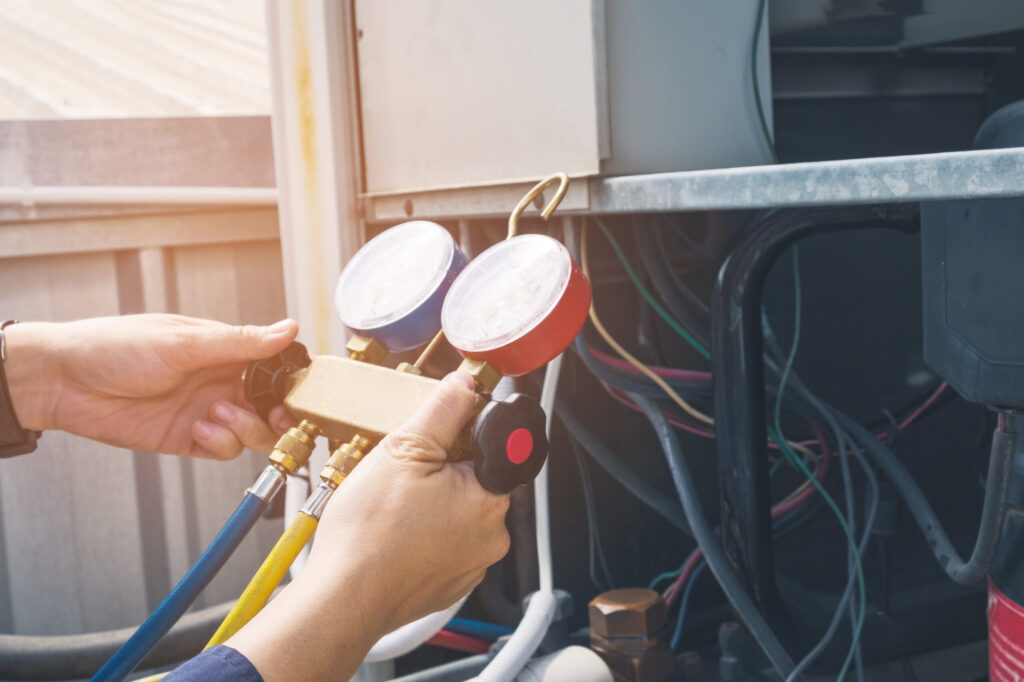 A person working on an air conditioner unit.