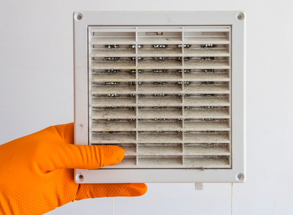 A hand is holding an air vent with the words " shut down ".